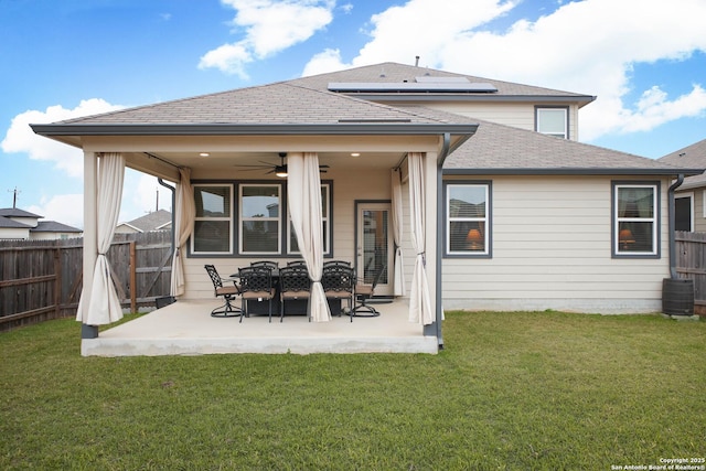 back of house featuring a patio area, a lawn, and ceiling fan