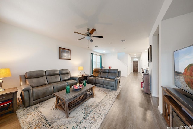 living room featuring ceiling fan and light wood-type flooring