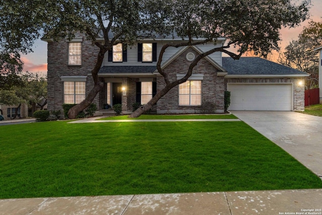 view of front of property with a garage and a yard