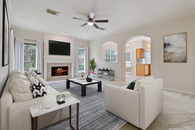 carpeted living room with ceiling fan