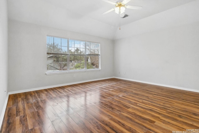 empty room featuring vaulted ceiling, ceiling fan, and dark hardwood / wood-style flooring