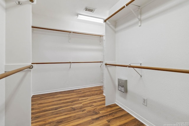 spacious closet featuring dark wood-type flooring