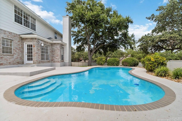 view of swimming pool featuring a patio area