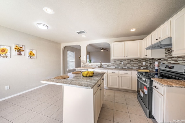 kitchen featuring white cabinetry, stainless steel range with electric stovetop, a kitchen island, sink, and light tile patterned flooring