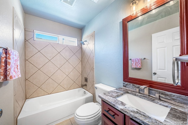 full bathroom with tiled shower / bath combo, vanity, and toilet