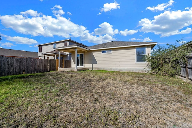 back of house with a yard