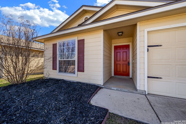 doorway to property with a garage