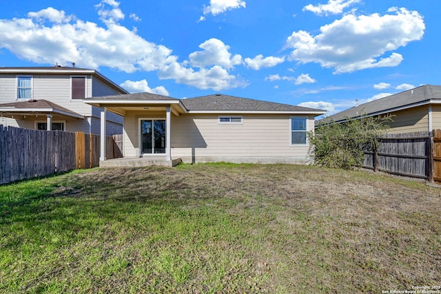 rear view of property with a patio area and a lawn