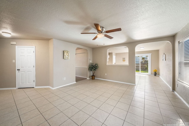 tiled spare room with ceiling fan