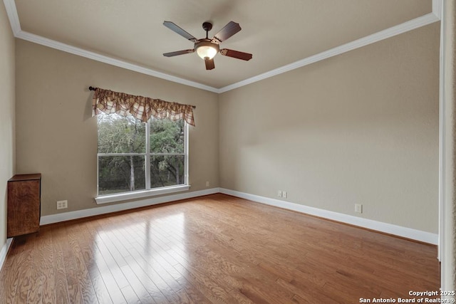 unfurnished room featuring hardwood / wood-style floors, crown molding, and ceiling fan