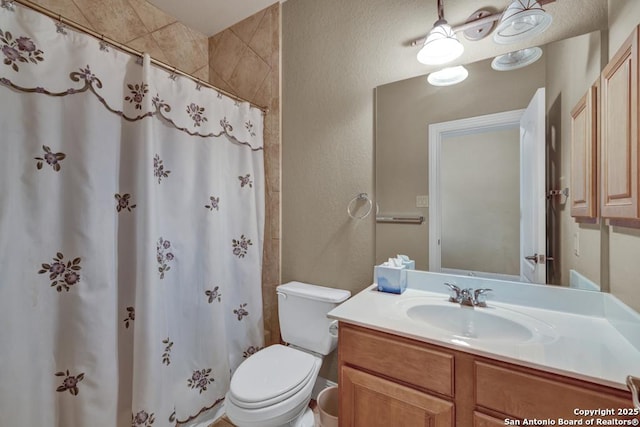 bathroom with vanity, walk in shower, and toilet