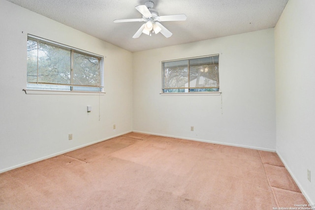 carpeted empty room with a textured ceiling and ceiling fan