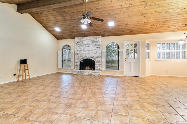 unfurnished living room with wood ceiling, a stone fireplace, light tile patterned floors, and ceiling fan