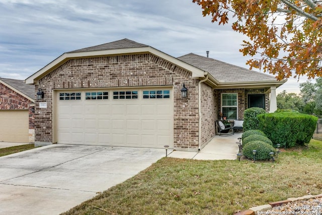 ranch-style home featuring a garage and a front yard