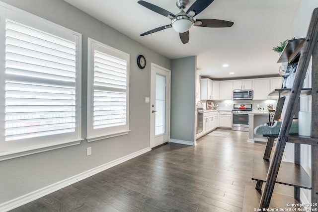 kitchen featuring white cabinetry, appliances with stainless steel finishes, a wealth of natural light, and backsplash