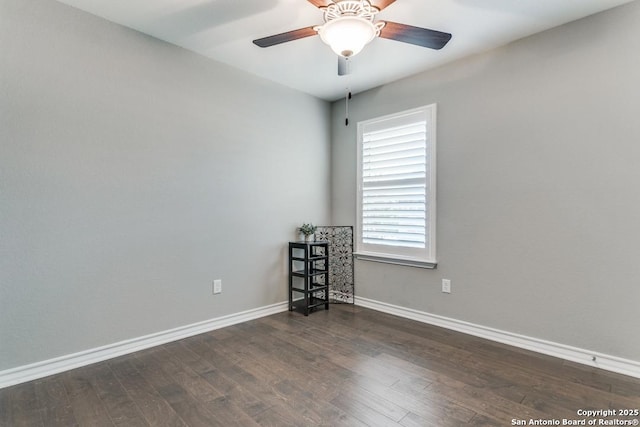 empty room with ceiling fan and dark hardwood / wood-style floors