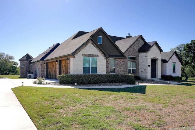 view of front of house featuring a garage and a front lawn