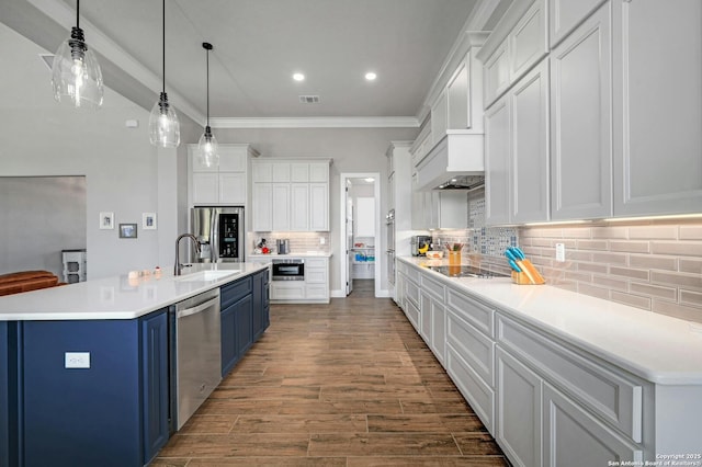 kitchen with blue cabinets, white cabinetry, hanging light fixtures, and stainless steel appliances