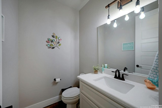 bathroom with hardwood / wood-style flooring, vanity, and toilet