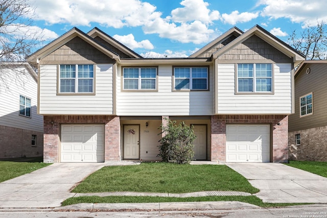 view of front facade with a garage and a front lawn