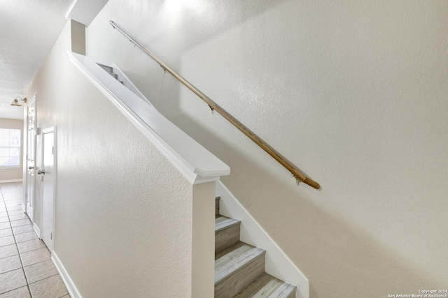 staircase with tile patterned flooring