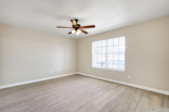 empty room with ceiling fan and light wood-type flooring