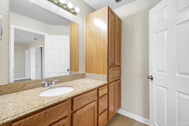 bathroom featuring tile patterned flooring and vanity