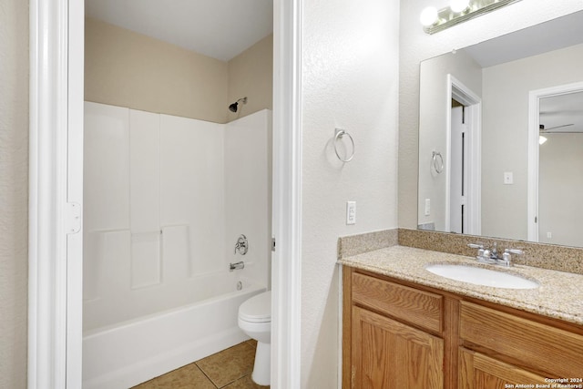 full bathroom featuring washtub / shower combination, tile patterned floors, toilet, and vanity