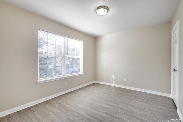 empty room with hardwood / wood-style flooring