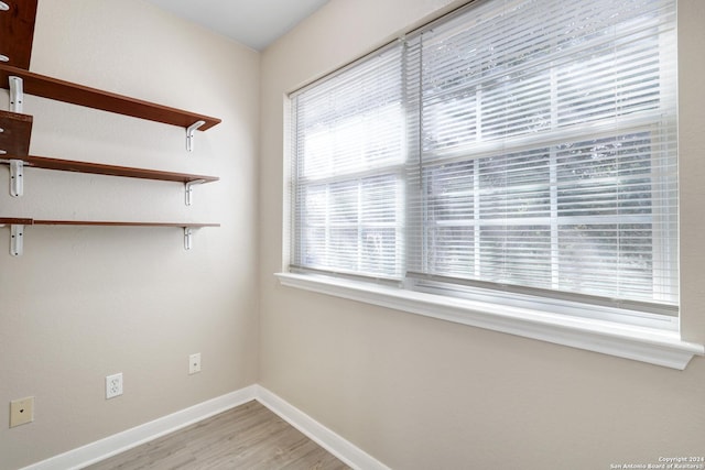 spare room with hardwood / wood-style flooring and a healthy amount of sunlight