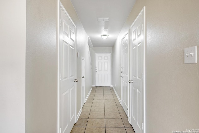 hall with light tile patterned floors