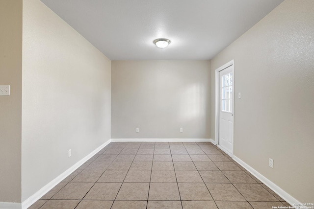 unfurnished room featuring light tile patterned flooring