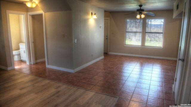 empty room with tile patterned floors and ceiling fan