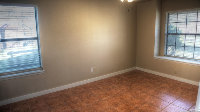 unfurnished room with tile patterned flooring