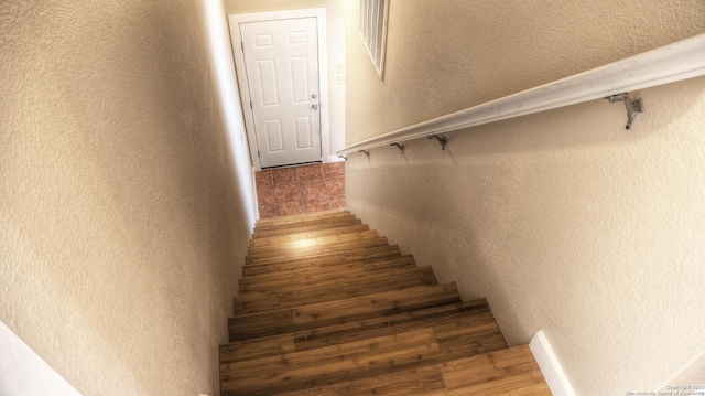 stairs featuring hardwood / wood-style floors