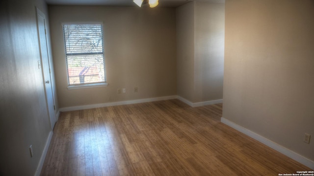 unfurnished room with hardwood / wood-style flooring