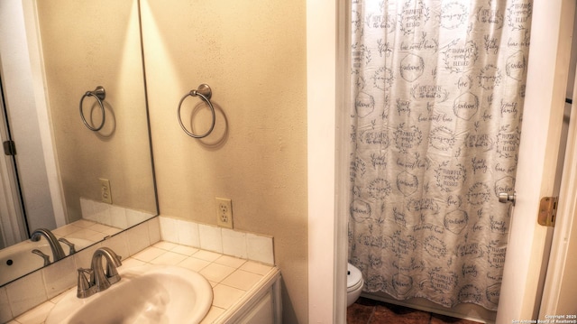 bathroom featuring vanity, toilet, and a shower with shower curtain