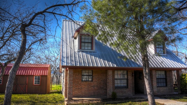 back of property featuring a storage unit