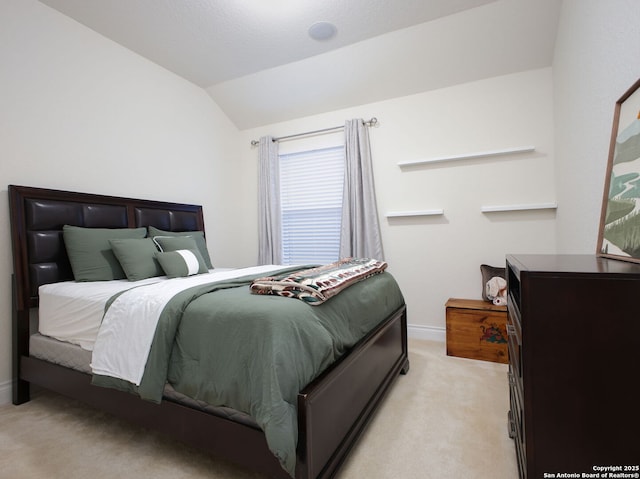 carpeted bedroom featuring vaulted ceiling