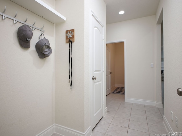 hallway featuring light tile patterned flooring