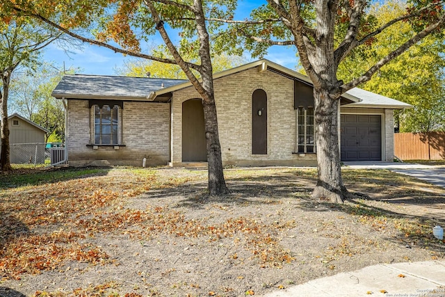 single story home with cooling unit and a garage