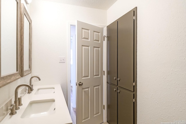 bathroom with vanity and a textured ceiling