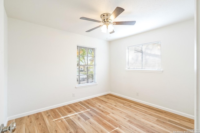 empty room with wood-type flooring and ceiling fan