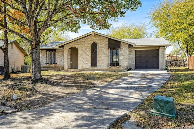 single story home featuring a garage and central AC unit