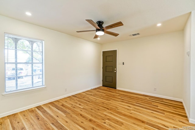 empty room with ceiling fan and light wood-type flooring