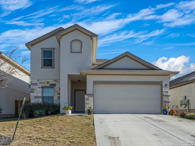 view of front facade with a garage and a front lawn