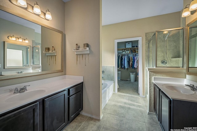 bathroom with tile patterned flooring, vanity, and plus walk in shower