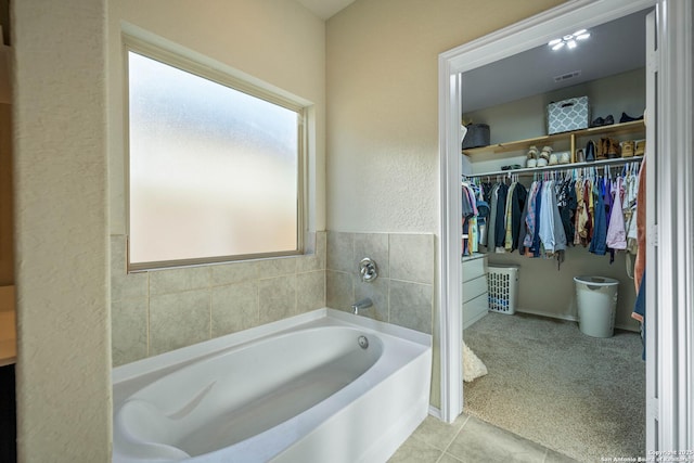 bathroom featuring tile patterned flooring and a bathing tub