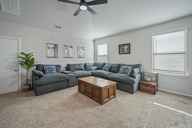 living room featuring ceiling fan, light colored carpet, lofted ceiling, and a textured ceiling