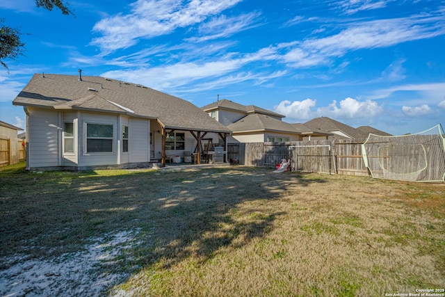 rear view of house featuring a patio area and a lawn